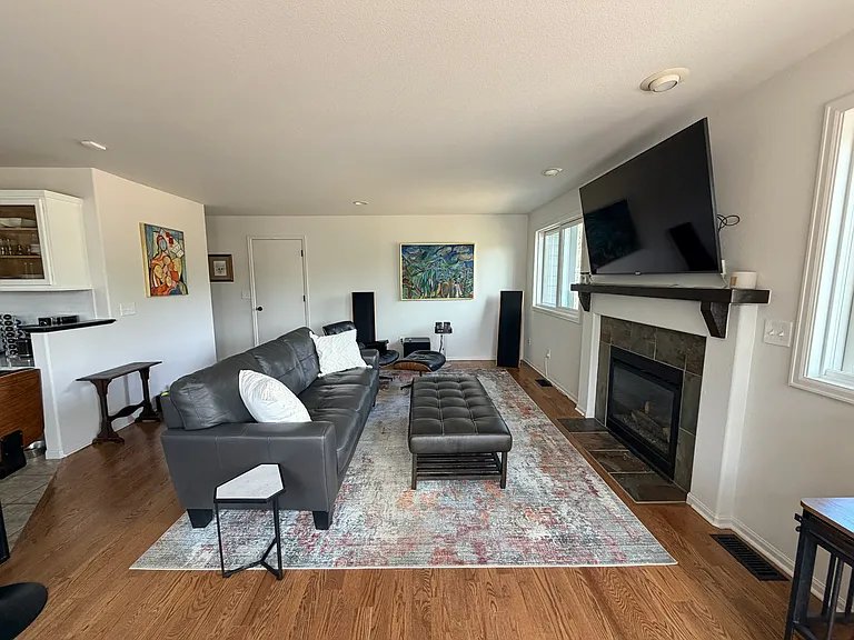 Living space outside of kitchen and opens up to deck area. Hardwood floors, gas fireplace, door to 2-car garage