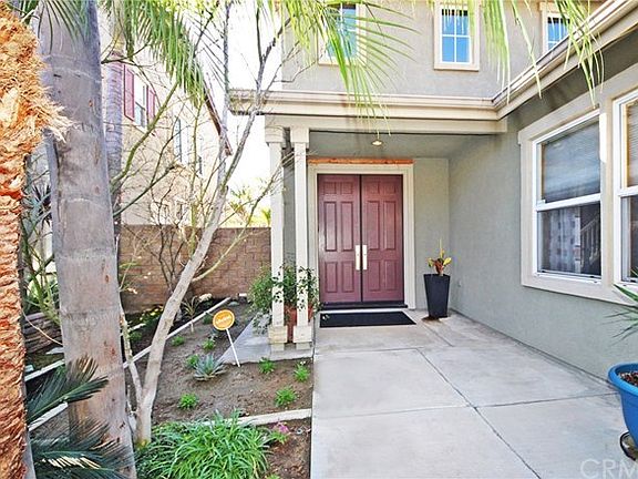 Inviting covered entryway with double doors.