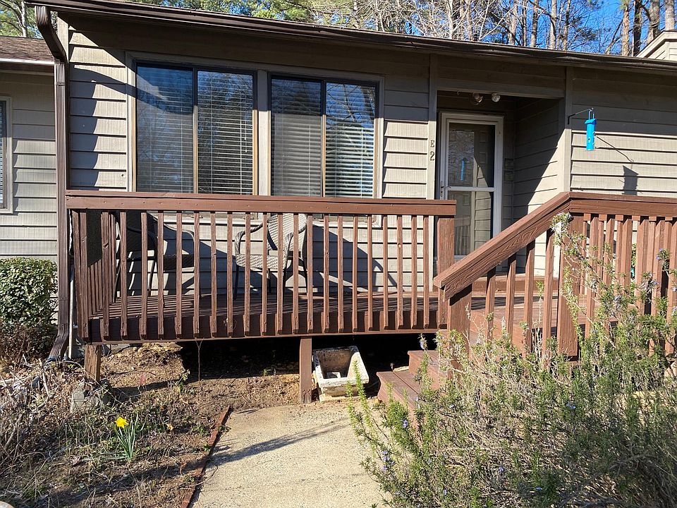 Front of home with new porch and two porch chairs. A little garden available for those that like gardening.
