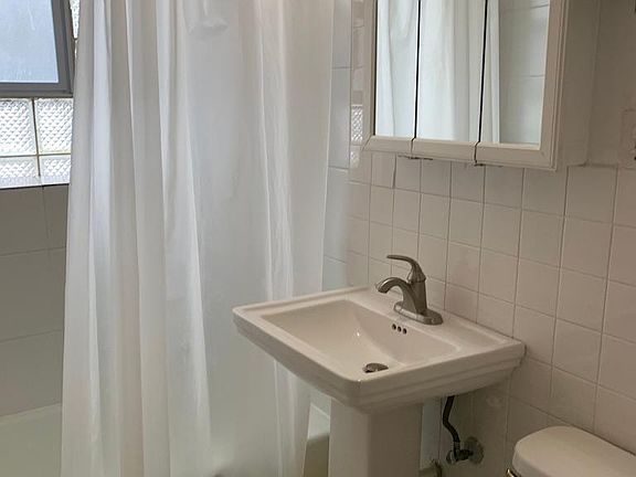 BATHROOM (tub and shower). Storage on left.