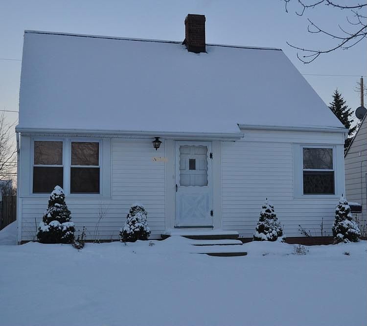 Neatly landscaped front yard with raised flower beds