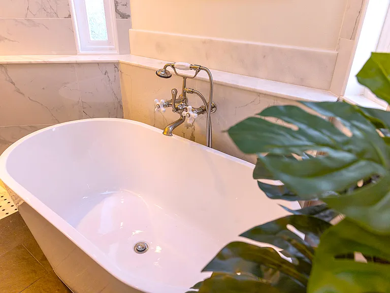 Relax in the master soaking tub perfectly placed under a skylight_soak away your cares while enjoying natural light and a view of the sky above. Your personal spa retreat awaits.