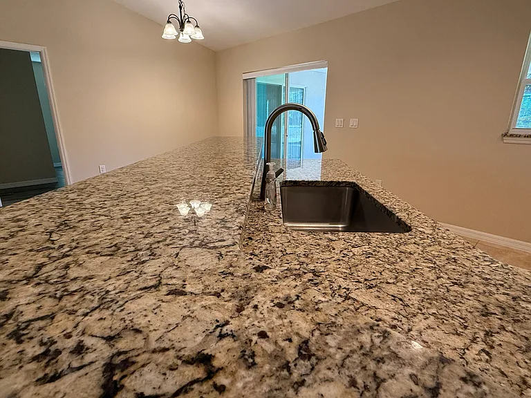 Granite Counter tops in kitchen area with breakfast area.