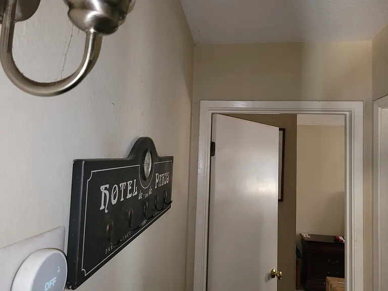 Restroom and thermostat in close proximity to the bedroom.