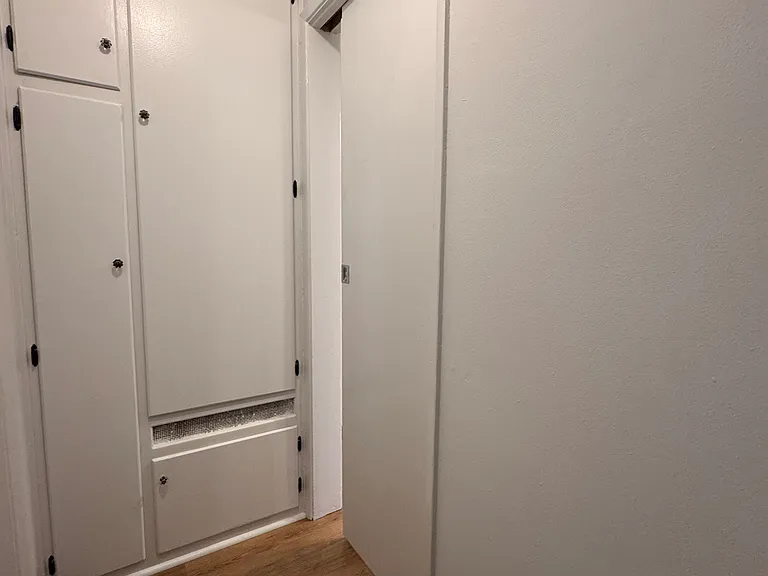 Hallway storage with pocket door for privacy