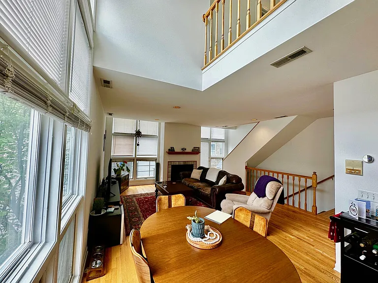 LIVING/DINING AREA FROM KITCHEN 2 STORY WALL OF GLASS WITH LOFT ABOVE ON 2ND LEVEL