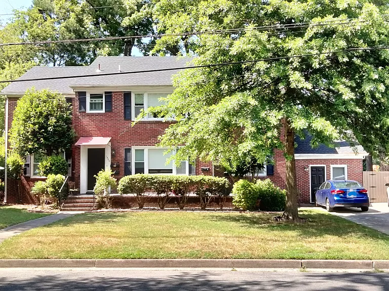 Triplex street view. Center entry to two upstairs apartments (furnished studio on left, two bedroom on right). Right side entry to this apartment.