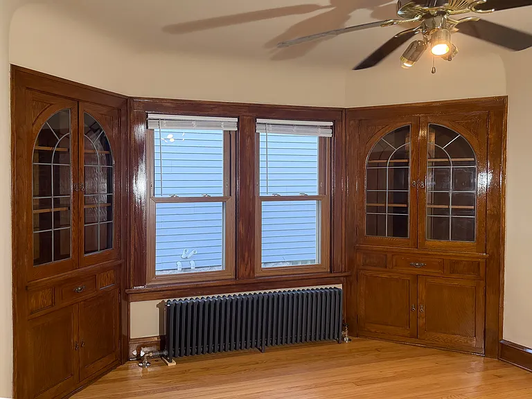 Dining room with good windows, built in cabinets, wood floors, and refinished woodwork.