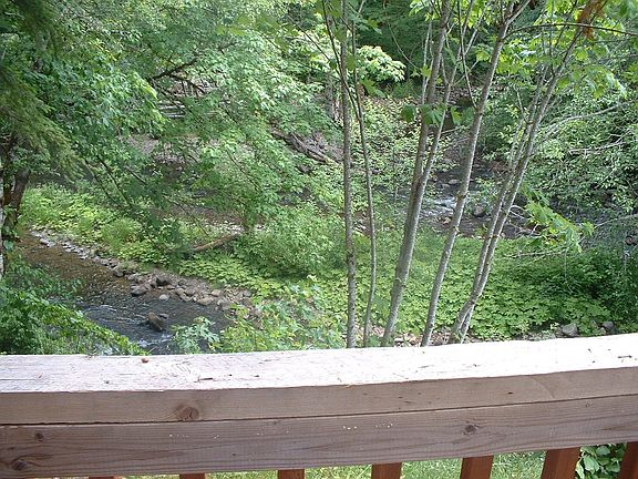 Deck out back door of Cabin Overlooking Creek