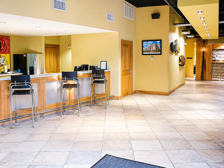 Modern lobby featuring a sleek counter and bar-top area_great for working, gathering, or quick meetings.