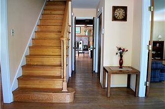 Wide center hall foyer with exposed hardwoods