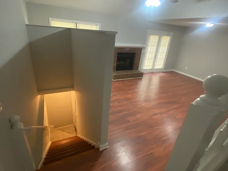 Den and stairway to basement from stairs.