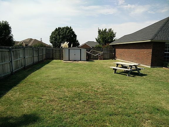Back yard/Storage Shed
						:
						Back yard view showing Storage Shed