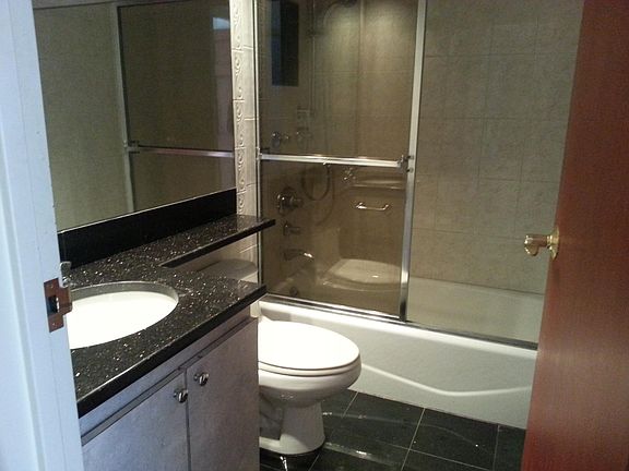 Rear left bathroom with black granite