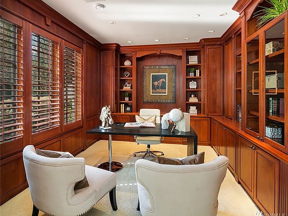 Main floor dedicated office has gorgeous custom, Cherry built-ins and French doors.