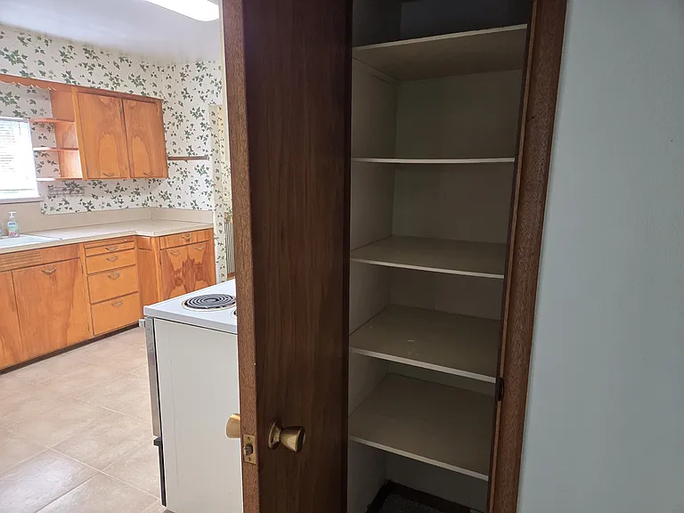 Small Linen Closet in Hallway next to Kitchen.