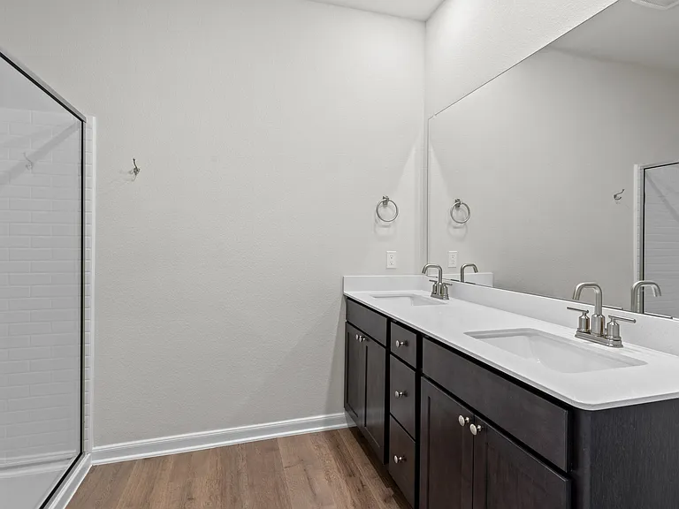 The master bathroom has a large, dual-sink vanity.