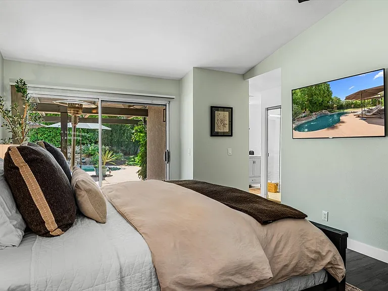 1st /Primary Bedroom with bathroom and walk in closet, TV - private access to patio/backyard