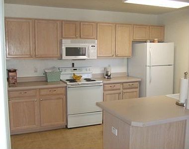 Kitchen w full laundry room at left.