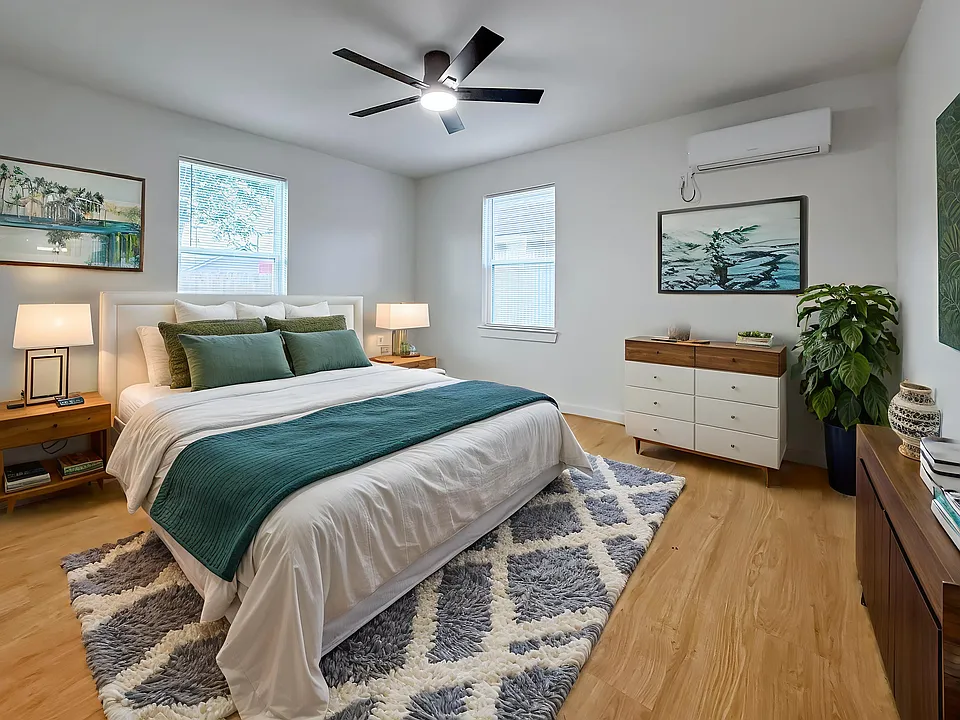 Discover the perfect blend of comfort and style in this virtually staged bedroom, featuring a cozy bed, sleek furnishings, and a modern ceiling fan, all set against a backdrop of natural light and soothing decor.