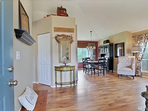 Light and bright living room and dining area with vaulted ceilings.