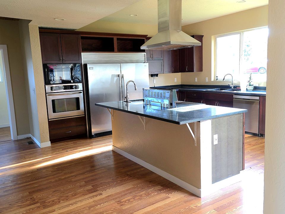 Chef's kitchen including granite large island where people can set up to bar, new stove, hood fan, dishwasher, built in microwave, double commercial freezer n fridge, hand washing sink and double dishes sink, extra built in wall stove, large knook area .