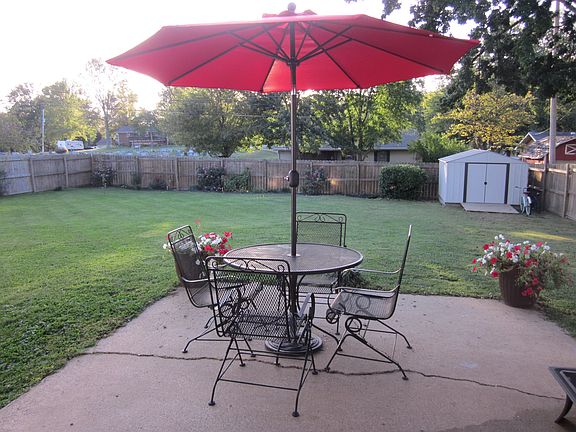 Fenced in backyard with shed