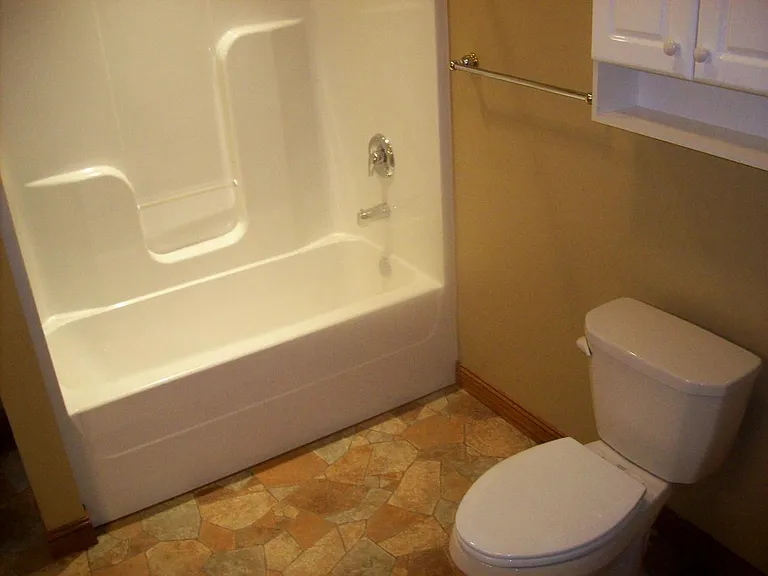 large bath which also has the front load washer and dryer pl
