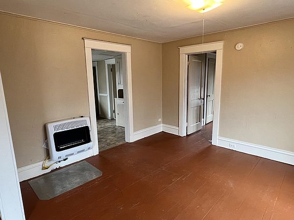 Dinning room, looking into bedroom #2 and kitchen. Brand new high efficiency heater shown in photo.