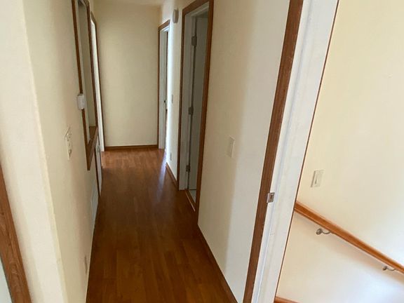 Upstairs hallway leading to two full bathrooms and two bedrooms