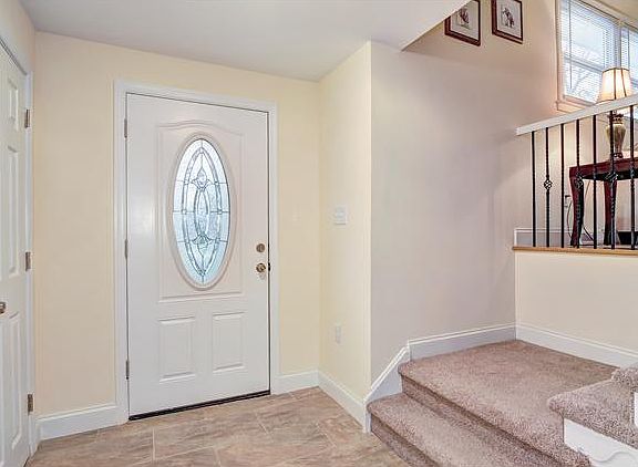Welcoming foyer with tile flooring