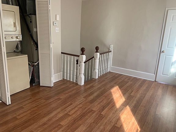as you enter the Apartment - shows Beautiful Laminating Flooring and Stackable W/D
