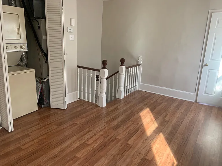 as you enter the Apartment - shows Beautiful Laminating Flooring and Stackable W/D