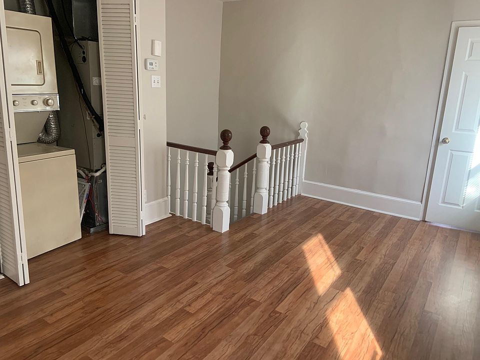 as you enter the Apartment - shows Beautiful Laminating Flooring and Stackable W/D