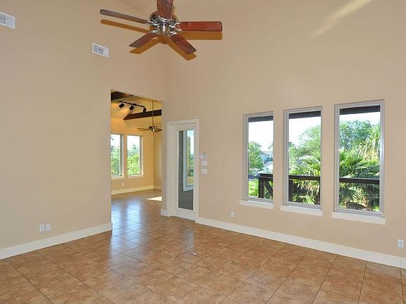 Entrance Into the Living Area with Wall of Windows, Large Cut Tile Flooring Throughout, and 17' Ceilings. **Built Energy Efficient**
