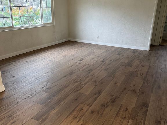 View from front door into living room (new flooring and blinds)