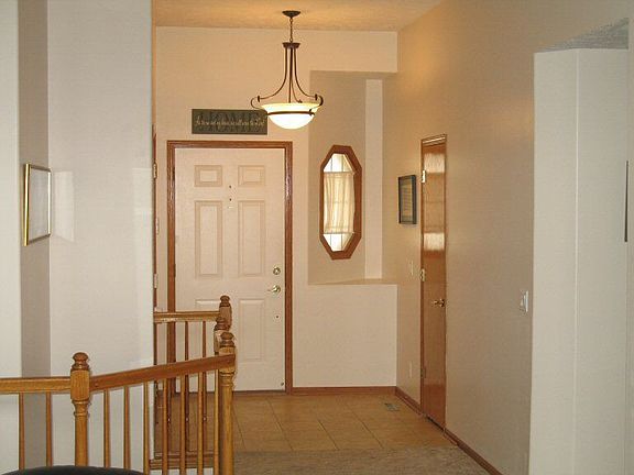 Entryway with pendant light and cermamic tile.