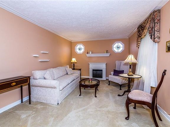 Living room has an electric fireplace to keep you warm on chilly winter evenings.