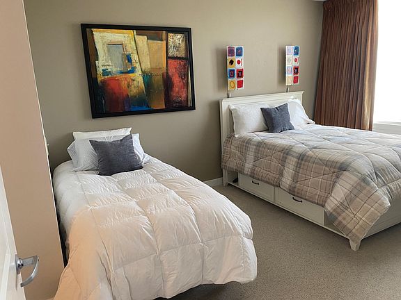 2nd bedroom with one full-sized bed and one xl-twin bed. Storage unit under full-sized bed.