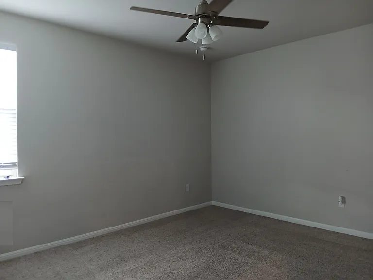 Guest bedroom with a ceiling fan