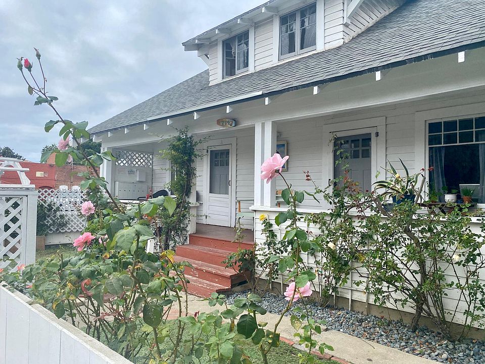 Front of the property with garden, yard and porch.