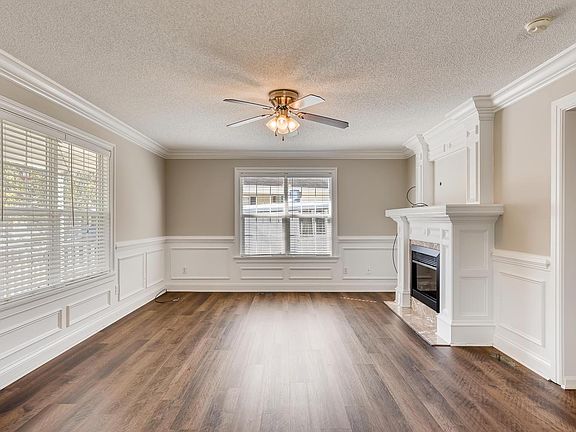 Living Room with Fireplace, large windows and luxury vinyl plank flooring.