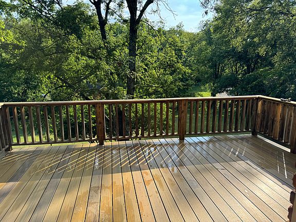 Newly installed composite deck overlooking .5 acre lot with lots of mature trees.