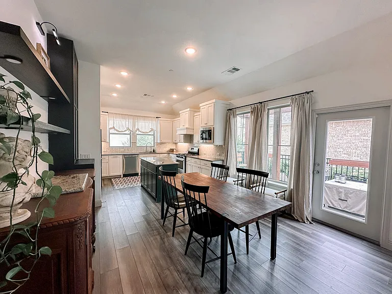 Dining area featuring natural lighting and door to fenced yard and pergola