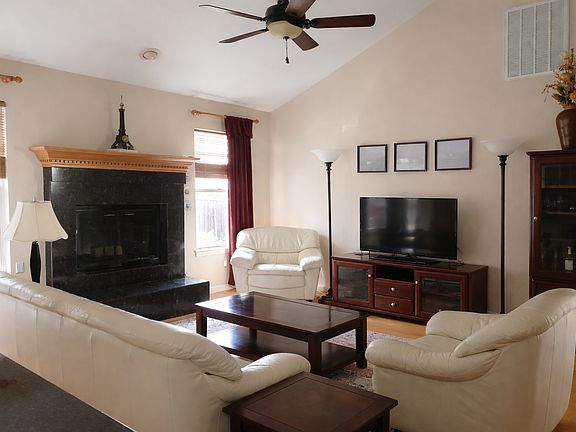 Family room with vaulted ceiling, gas fireplace and access to one of three decks.