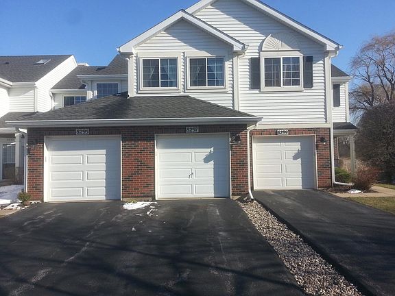 One car garage with lots of shelving and cabinets for storag