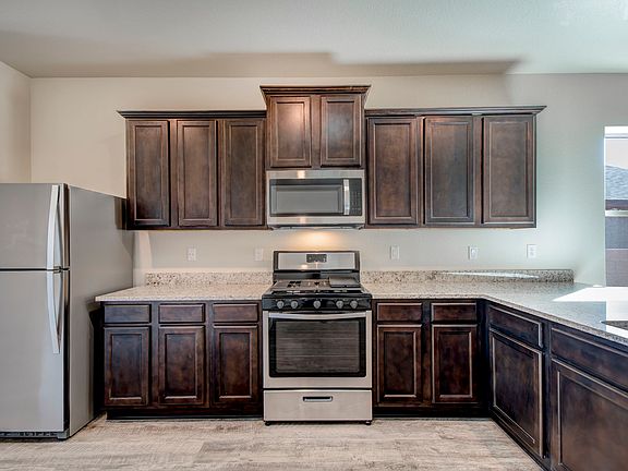 Chef-ready kitchen with granite countertops and espresso cabinetry.
