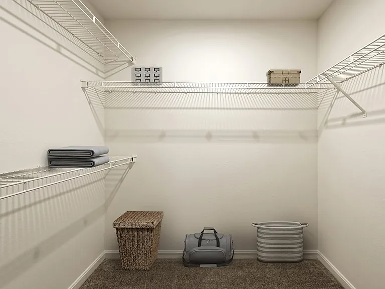 Walk in closet with linen rack and storage space