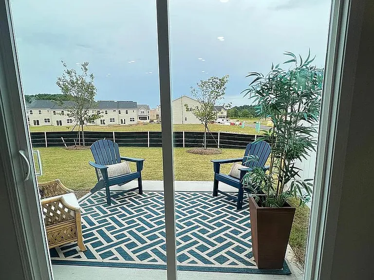 patio facing green open village for kids/dogs to play