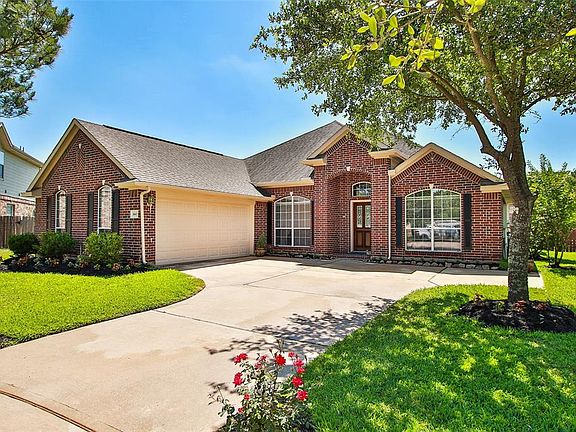 Attached two-car garage, beautiful landscaping and trees.